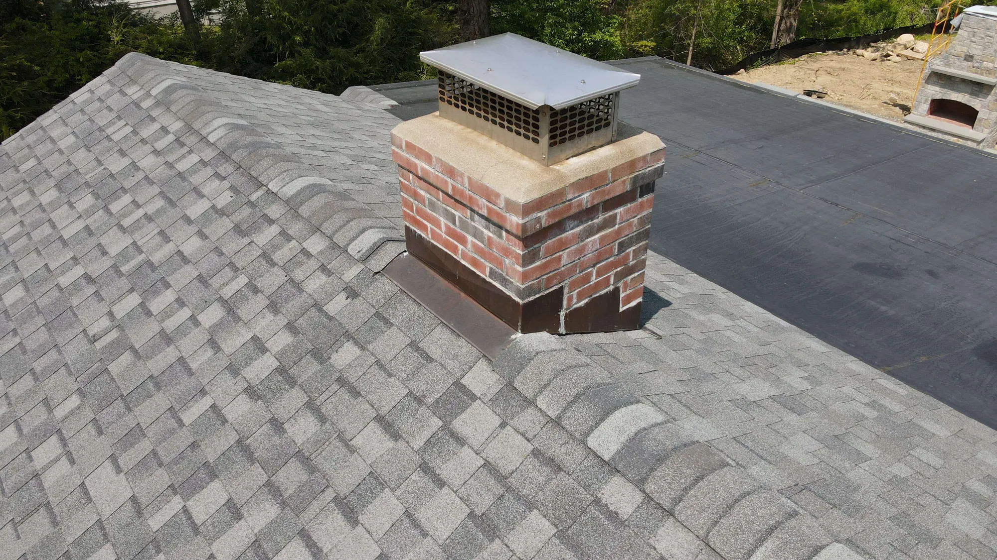 New step flashing installed around brick chimney in Ridgefield CT