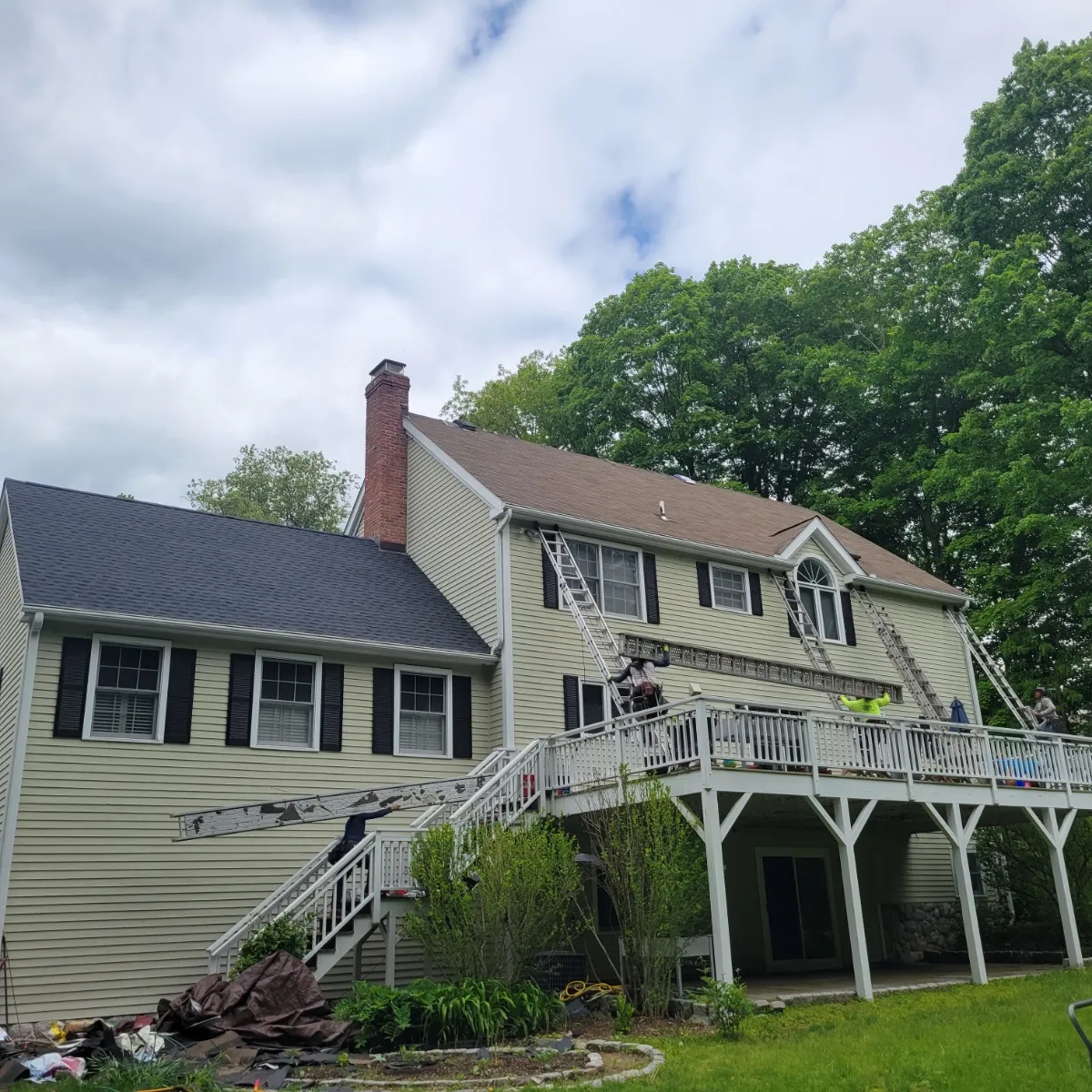 Apex roofing crew installing asphalt shingles on a Wilton CT home