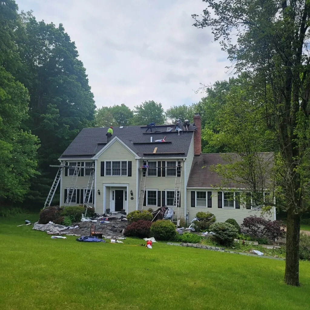 Apex Roofing and Siding crew working on a siding replacement in Fairfield County CT